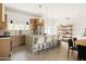 Modern kitchen features a large island with seating, stainless steel appliances, and stylish pendant lighting at 7620 N 12Th Pl, Phoenix, AZ 85020