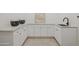 Bright laundry room featuring ample cabinet space and neutral countertops at 7620 N 12Th Pl, Phoenix, AZ 85020