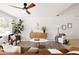 Open-concept living room with natural lighting, ceiling fan, and sleek modern furniture at 7620 N 12Th Pl, Phoenix, AZ 85020