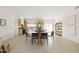Open-concept living area with dining table, tile floors, and bright natural light at 7620 N 12Th Pl, Phoenix, AZ 85020