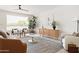 Inviting living room featuring a large window, modern decor, and stylish furnishings at 7620 N 12Th Pl, Phoenix, AZ 85020