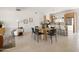 Bright, open-concept living area with tile floors, dining table and kitchen in background at 7620 N 12Th Pl, Phoenix, AZ 85020