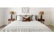 Close up of the main bedroom with a stylish bed, neutral decor, and bedside lamps at 7620 N 12Th Pl, Phoenix, AZ 85020