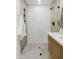 Elegant walk-in shower with white subway tile and marble accents, plus built-in shelving at 7620 N 12Th Pl, Phoenix, AZ 85020