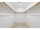 Spacious walk-in closet with wooden rails, tile floors, and bright lighting at 7620 N 12Th Pl, Phoenix, AZ 85020