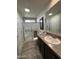 Bathroom featuring a glass enclosed shower, dark vanity, and neutral finishes at 7807 E Main St # Cc-98, Mesa, AZ 85207