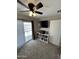 Bright carpeted bedroom features a ceiling fan, media center, and sliding glass door leading to a private balcony at 7807 E Main St # Cc-98, Mesa, AZ 85207