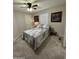 Neutral bedroom with plush carpeting, ceiling fan, side tables, and art at 7807 E Main St # Cc-98, Mesa, AZ 85207