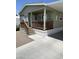 Inviting, light green home featuring a covered front porch with wood railing and stairs at 7807 E Main St # Cc-98, Mesa, AZ 85207