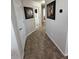 Hallway with tile floors and neutral paint with artwork on the walls at 7807 E Main St # Cc-98, Mesa, AZ 85207