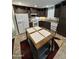 Kitchen featuring dark wood cabinets, stainless appliances, tile floors and center island at 7807 E Main St # Cc-98, Mesa, AZ 85207