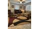 Cozy living room featuring tile floors, neutral paint, ceiling fan, and an eye catching area rug at 7807 E Main St # Cc-98, Mesa, AZ 85207