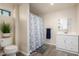 Bright bathroom featuring a vanity with sink, mirror, and shower with a decorative curtain at 8042 W Mariposa Dr, Phoenix, AZ 85033