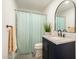 Beautiful bathroom featuring a granite countertop vanity and shower with blue curtain at 8042 W Mariposa Dr, Phoenix, AZ 85033