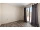 Bright bedroom showcasing sliding glass doors leading to a patio and sleek wood-look flooring at 8042 W Mariposa Dr, Phoenix, AZ 85033