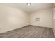Bright bedroom with wood-look floors and a window-mounted air conditioning unit at 8042 W Mariposa Dr, Phoenix, AZ 85033