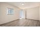 Bedroom featuring wood-look floors and a window with light-filtering blinds at 8042 W Mariposa Dr, Phoenix, AZ 85033