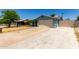 View of the house including the garage, driveway, and side yard at 8042 W Mariposa Dr, Phoenix, AZ 85033