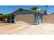 View of the house including the garage, driveway, and side yard at 8042 W Mariposa Dr, Phoenix, AZ 85033