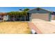 Charming single-story home with a well-maintained lawn and a cozy, covered porch entrance at 8042 W Mariposa Dr, Phoenix, AZ 85033