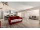 Spacious open-plan living area with wood-look floors, stylish furniture, and an open layout at 8042 W Mariposa Dr, Phoenix, AZ 85033