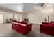Bright living room featuring modern decor, comfortable seating, and a ceiling fan at 8042 W Mariposa Dr, Phoenix, AZ 85033