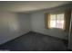 Bedroom featuring a window with curtains and gray carpet at 8114 E Jackrabbit Rd, Scottsdale, AZ 85250