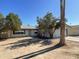 Ranch style home featuring mature trees and desert landscaping in the front yard at 8114 E Jackrabbit Rd, Scottsdale, AZ 85250