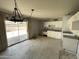 Kitchen featuring white cabinets, basic appliances and tile flooring with backyard access at 8114 E Jackrabbit Rd, Scottsdale, AZ 85250