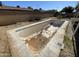 In-ground pool needing repairs with surrounding patio and block wall at 8114 E Jackrabbit Rd, Scottsdale, AZ 85250