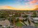 Stunning aerial view of a neighborhood showcasing well-maintained homes, mature trees, and beautiful landscaping at sunset at 8604 S Oak St, Tempe, AZ 85284