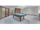 Finished basement with a fireplace, sliding door access to the exterior and a billiards table at 8604 S Oak St, Tempe, AZ 85284