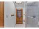 Bathroom featuring wooden door with window panel and a frosted glass shower at 8604 S Oak St, Tempe, AZ 85284