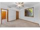 Bedroom with neutral carpet, a window, and a ceiling fan at 8604 S Oak St, Tempe, AZ 85284