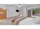 Spacious bedroom featuring carpet, ceiling fan, TV, and access to the outdoors at 8604 S Oak St, Tempe, AZ 85284