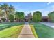 Inviting single-story home with a well-manicured lawn, mature trees, and a walkway leading to the front entrance at 8604 S Oak St, Tempe, AZ 85284