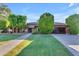 Beautiful single-story home with a well-manicured lawn, mature trees, and a spacious driveway leading to a two-car garage at 8604 S Oak St, Tempe, AZ 85284