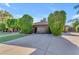 Charming single-Gathering home with a well-manicured lawn, mature trees, and a spacious driveway leading to a two-car garage at 8604 S Oak St, Tempe, AZ 85284