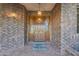 Elegant front entrance with a solid wood door, brick facade, and decorative lighting, exuding warmth and sophistication at 8604 S Oak St, Tempe, AZ 85284
