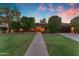 Charming single-story home featuring a well-manicured lawn, mature trees, and a welcoming walkway to the front door at 8604 S Oak St, Tempe, AZ 85284