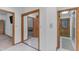 Hallway featuring multiple doors, a mirror, and tiled flooring at 8604 S Oak St, Tempe, AZ 85284