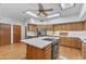 Bright kitchen with hardwood floors, stainless steel appliances, kitchen island, and ample counter space at 8604 S Oak St, Tempe, AZ 85284