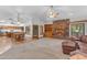 Spacious living room featuring a brick fireplace, built-in shelving, and an adjacent kitchen and dining area at 8604 S Oak St, Tempe, AZ 85284