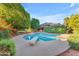 Beautiful backyard pool with diving board, mature landscaping, and blue sky, perfect for outdoor living at 8604 S Oak St, Tempe, AZ 85284