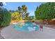 Backyard pool area with mature trees, concrete deck, and refreshing blue water and landscaping at 8604 S Oak St, Tempe, AZ 85284