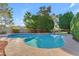 Outdoor pool surrounded by lush greenery, a stone deck, and clear blue skies at 8604 S Oak St, Tempe, AZ 85284