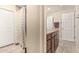 Well-lit bathroom featuring a shower with patterned curtains and a vanity with granite counters and wood cabinets at 8620 E Sells Dr, Scottsdale, AZ 85251