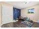 This cheerful bedroom features space decor, a playful hanging swing and rich wood floors at 8620 E Sells Dr, Scottsdale, AZ 85251