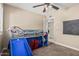 bedroom features a bunk bed with slide, carpeted floors, and ample natural light from the window at 8620 E Sells Dr, Scottsdale, AZ 85251