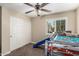 bedroom with carpet, light walls, slide bunk bed and a shuttered window at 8620 E Sells Dr, Scottsdale, AZ 85251